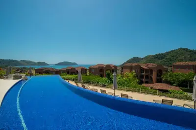 a swimming pool at a resort with mountains in the background at Montecielo 4A - 3 bdr 3 1 ang a half bath Ocean View in La Mona
