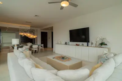 a living room with a white couch and a tv at Montecielo 4A - 3 bdr 3 1 ang a half bath Ocean View in La Mona