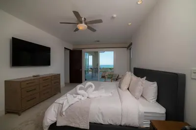 a bedroom with a bed with a dresser and a television at Montecielo 4A - 3 bdr 3 1 ang a half bath Ocean View in La Mona
