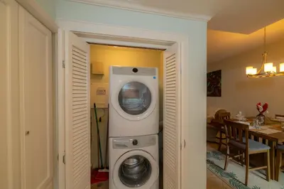 a washer and dryer in a living room with a table at Veranda 3B - 2 Bedr 2 Bath in La Mona