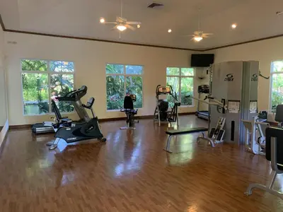 a gym with treadmills and exercise bikes in a room at Veranda 3B - 2 Bedr 2 Bath in La Mona