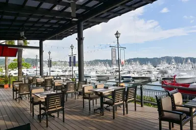 a patio with tables and chairs and a marina at Veranda 3B - 2 Bedr 2 Bath in La Mona