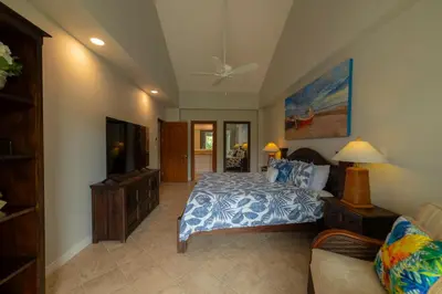 a bedroom with a bed and a tv and a couch at Veranda 4B - 3bdr 3bath in La Mona
