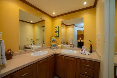 a bathroom with two sinks and two mirrors at Veranda 5F - 2 bdr 2 bath in La Mona