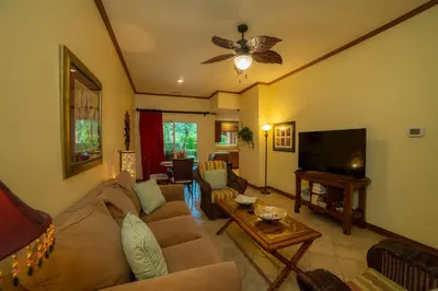 a living room with a couch and a flat screen tv at Veranda 5F - 2 bdr 2 bath in La Mona