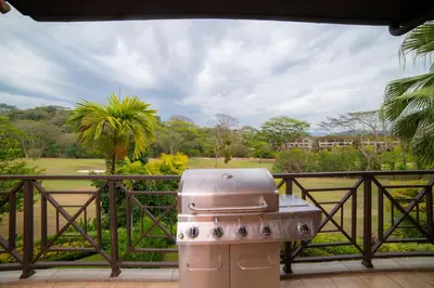 a grill on a balcony with a view of a park at Veranda 6C - 3 bdr 3 bath in La Mona