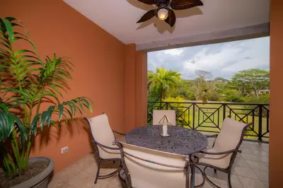 a dining room with a table and chairs and a balcony at Veranda 6C - 3 bdr 3 bath in La Mona