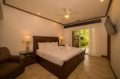 a bedroom with a bed and a couch and a window at Veranda 6F - 2bdr 2 bth in La Mona