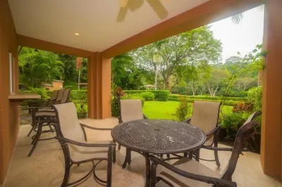 a patio with a table and chairs and a garden at Veranda 8H 3 bedr 3 bath in La Mona