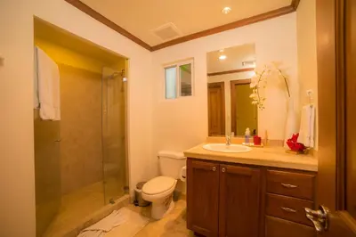 a bathroom with a toilet and a sink and a shower at Veranda 8H 3 bedr 3 bath in La Mona