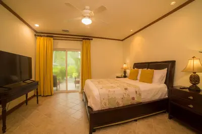 a bedroom with a bed and a flat screen tv at Veranda 8H 3 bedr 3 bath in La Mona
