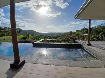 a swimming pool with a view of the mountains at Luxury villa Potrero in Potrero