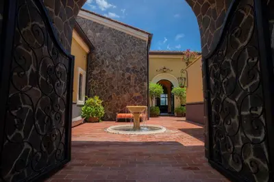 a courtyard with a fountain in the middle of a building at Villa Angel 4 bdr Ocean View private pool Family in La Mona