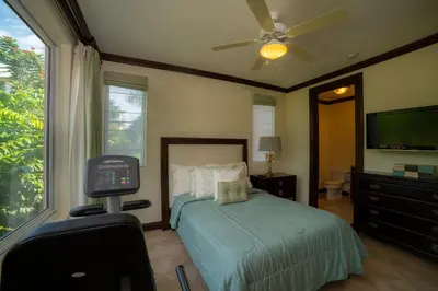 a bedroom with a bed and a flat screen tv at Altavista 2C 3 bdr 3 bath Ocean View in La Mona