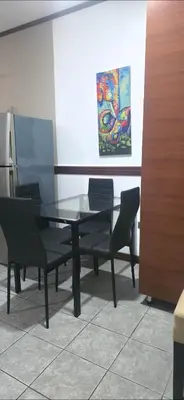 a table and chairs in a room with a painting at Apartamentos Adela cerca embajada americana in San José