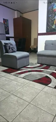 a room with two beds and a rug on the floor at Apartamentos Adela cerca embajada americana in San José