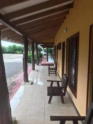 a row of benches sitting on the side of a building at Hotel El Paraje in Santa Cruz