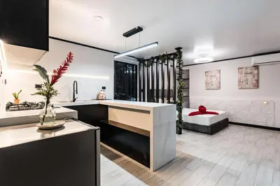 a kitchen with a sink and a living room at Aralias Villas in Agua Azul