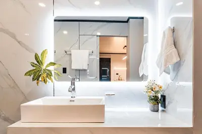 a white bathroom with a sink and a mirror at Aralias Villas in Agua Azul