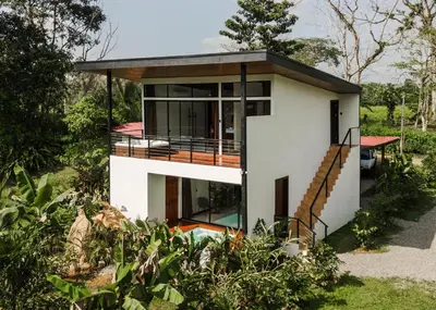 a house with a view of the yard at Aralias Villas in Agua Azul