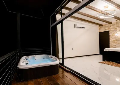 a bathroom with a jacuzzi tub and a sink at Aralias Villas in Agua Azul