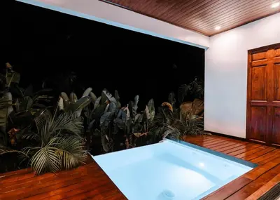 a bath tub in a room with plants at Aralias Villas in Agua Azul