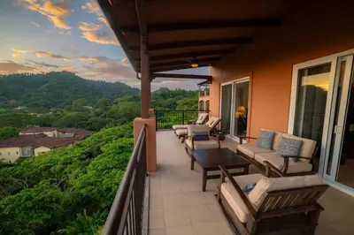 a balcony with chairs and a table and a view at Altavista 5A 3 bdr 3 bath Ocean View in La Mona