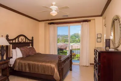 a bedroom with a bed with a ceiling fan and a window at Bay Residence 7C - 3 bdr 2 bath in La Mona