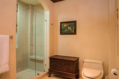 a bathroom with a toilet and a glass shower at Bay Residence 7C - 3 bdr 2 bath in La Mona