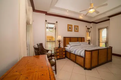 a bedroom with a bed and a table at Bella Vista 2B Bedr 3 1 and a half bath Pool View in La Mona