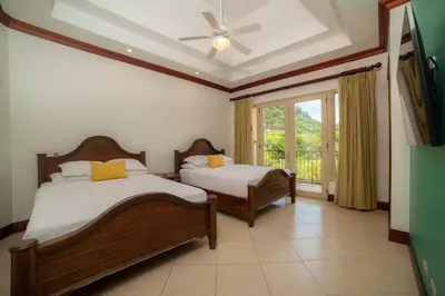 a bedroom with two beds and a window at Bella Vista 2B Bedr 3 1 and a half bath Pool View in La Mona