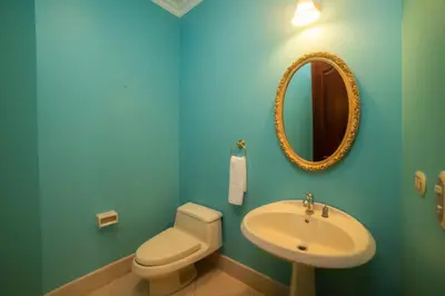 a blue bathroom with a toilet and a sink at Bella Vista 2B Bedr 3 1 and a half bath Pool View in La Mona
