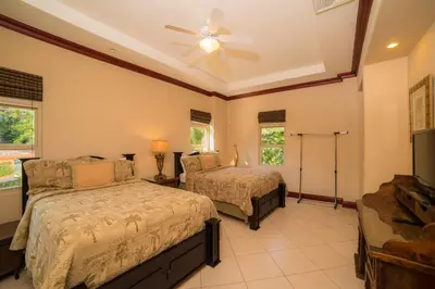 a bedroom with two beds and a ceiling fan at Bella Vista 2C - 3 bdr 3 1 and a half bath in La Mona
