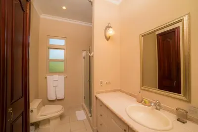 a bathroom with a sink and a toilet and a mirror at Bella Vista 2C - 3 bdr 3 1 and a half bath in La Mona