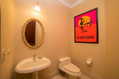 a bathroom with a sink and a toilet and a mirror at Bella Vista 2C - 3 bdr 3 1 and a half bath in La Mona
