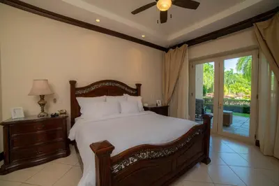 a bedroom with a large bed and a sliding glass door at Bella Vista 3F- 3 bdr 3 1 and a half Bath Family in La Mona