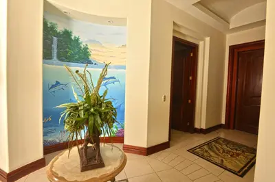 a hallway with a painting and a table with a plant at Bella Vista 4B - 3 bdr -3 1 and a half bath Ocean View in La Mona