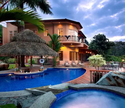 a resort with a swimming pool and a building at Casa Oasis 5 bdr private pool in La Mona