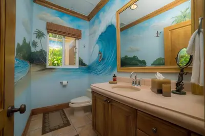 a bathroom with a sink and a wave painting on the wall at Casa Oasis 5 bdr private pool in La Mona