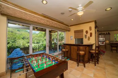 a living room with a pool table and a bar at Casa Oasis 5 bdr private pool in La Mona