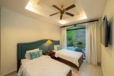 a bedroom with two beds and a ceiling fan at Casa Patron 6 bdr Private pool in La Mona