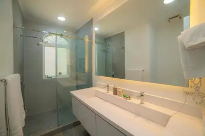 a bathroom with a sink and a glass shower at Colina 5D - 3 bdr 2 bath Family in La Mona