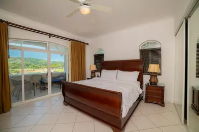 a bedroom with a bed and a balcony at Colina 5D - 3 bdr 2 bath Family in La Mona