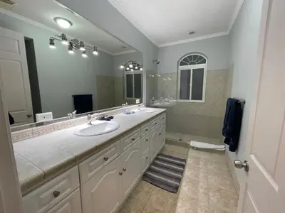 a bathroom with two sinks and a large mirror at Sweet fishing apartment in Isla Herradura