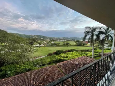 a balcony with a view of a golf course at Sweet fishing apartment in Isla Herradura