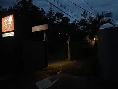 a sign for a bar in the dark at Donguis Rooms in San Pablo