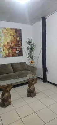 a living room with a couch and teddy bears on the floor at Rohrmoser a 100 metros de la embajada americana in San José