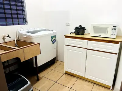 a kitchen with a sink and a microwave at Alto Cruz Executive Loft in Turrialba