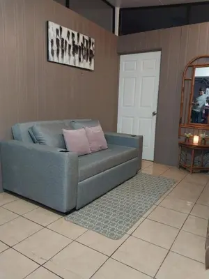 a blue couch sitting in a living room at Alto Cruz Executive Loft in Turrialba