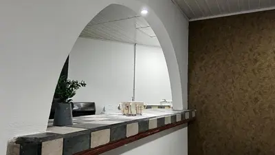 a bathroom with a large mirror on a counter at Executive Apartment Escazú in Escazu